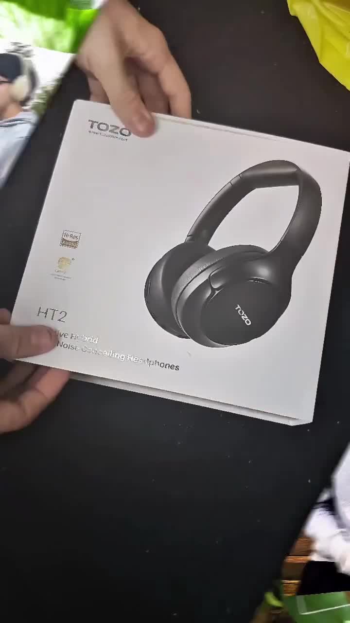 Creator wearing TOZO HT2 noise cancelling headphones